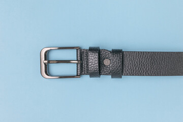 Black Leather Belt with Silver Buckle on Light Blue Background
