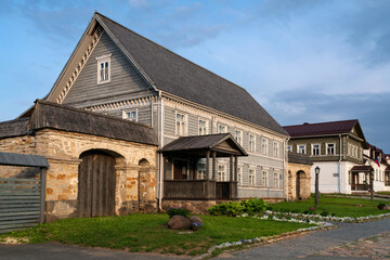 View of historical merchant buildings of estates on the main street of Izborsk Pechorskaya Street on a summer sunny day, Izborsk, Pskov region, Russia