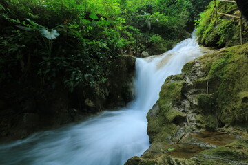 Obraz premium A Waterfall With A Waterfall In The Background And A Waterfall In The Middle