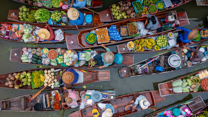 Aerial view Damnoen Saduak floating market, Farmer go to sell organic product, fruit, vegetable and Thai cuisine, Tourist visiting by boat, Ratchaburi, Thailand, Famous floating market in Thailand. © Kalyakan