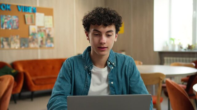 Caucasian male student guy pupil boy teen teenager studying laptop learning computer using pc study learn online education internet course homework prepare to exams school academy college university