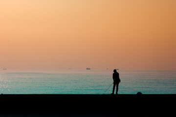 Fototapeta premium couple walking on the beach at sunset