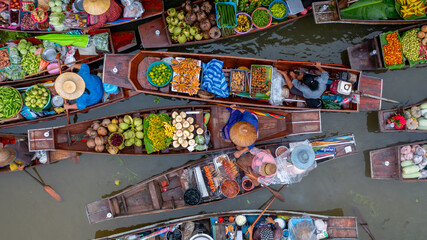 Aerial view Damnoen Saduak floating market, Farmer go to sell organic product, fruit, vegetable and Thai cuisine, Tourist visiting by boat, Ratchaburi, Thailand, Famous floating market in Thailand.