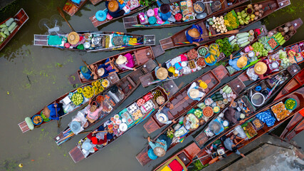 Aerial view Damnoen Saduak floating market, Farmer go to sell organic product, fruit, vegetable and Thai cuisine, Tourist visiting by boat, Ratchaburi, Thailand, Famous floating market in Thailand.