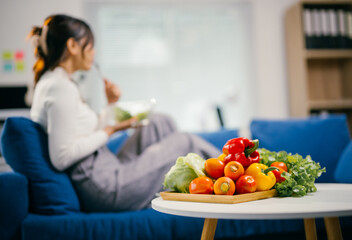 Businesswoman enjoying a healthy salad on a office couch, promoting work-life balance and wellness with fresh veggies