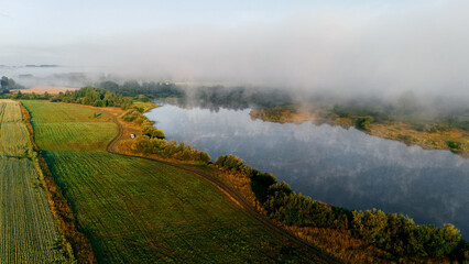Fog rises from the lake at dawn