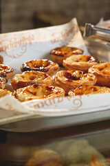 Fresh baked Pastel de nata or Pastel de belém .The most famous sweet in Portugal. Tart on baking sheet/