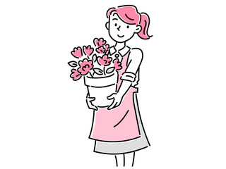 花が咲いた植木鉢を持った花屋の若い女性スタッフ
