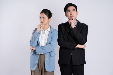 Image of an Asian business couple posing on a white background.