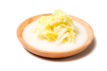 Chopped cooked napa cabbage served in savory coconut milk broth, perfect as a side dish with rice. Photographed on a white background.