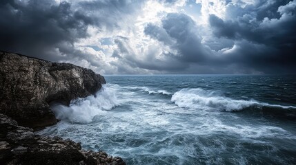 Obraz premium A dramatic cliffside view of the ocean during a storm