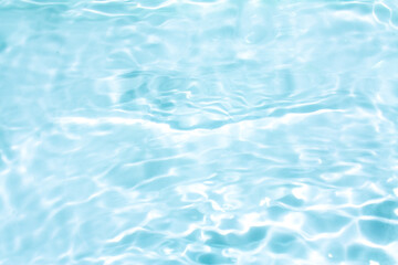 Fototapeta premium Blue water with ripples on the surface. Defocus blurred transparent blue colored clear calm water surface texture with splashes and bubbles. Water waves with shining pattern texture background.