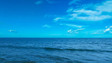 Nature of the beach and sea Summer with sunshine, sandy beaches, clear blue waters sparkling against the blue sky. On an island with good ecology and environment Background for summer vacation concept