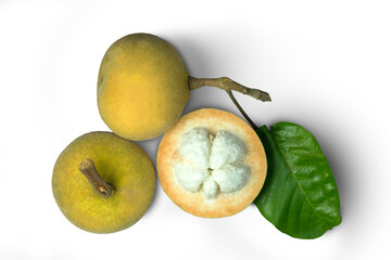 Fresh santols (Sandoricum koetjape, sentul, cotton fruit) whole with a brance, a half cut and green leaf isolated on white background with top view flat lay stack.