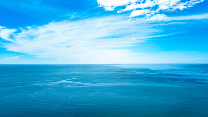 Obraz premium Nature of the beach and sea Summer with sunshine, sandy beaches, clear blue waters sparkling against the blue sky. On an island with good ecology and environment Background for summer vacation concept