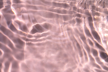 Pink water bubbles on the surface ripples. Defocus blurred transparent pink colored clear calm...