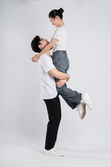 Image of Asian couple posing on white background.