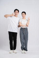 Image of Asian couple posing on white background.