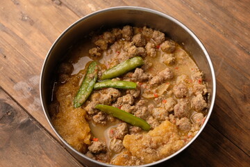 Sambal Goreng Krecek is a ground beef sambal with beef skin crackers, cooked with coconut milk, chili, and spices. Indonesian cuisine.