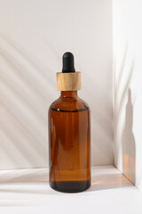 Cosmetic oil in a brown bottle with a wooden cap