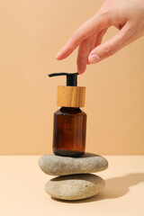 Cosmetic oil in a brown bottle with pebbles