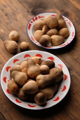 Volvariella volvacea is a species of edible mushroom cultivated throughout East and Southeast Asia and used extensively in Asian cuisines. straw mushroom in wooden box. jamur merang. 