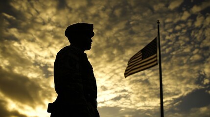 Silhouette of Soldier Standing Proudly with American Flag at Sunset