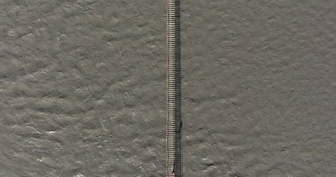 Top Down Aerial View Above Hussaini Suspension Bridge, Hunza River, Pakistan. People Crossing Dangerous Bridge near Passu Cones Mountains