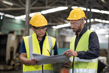 Group of male engineer worker discuss and working together in industry factory. Male engineer repairing or maintenance CNC machine in factory