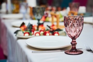 A table full of food and drinks with a variety of dishes and glasses. Scene is inviting and celebratory