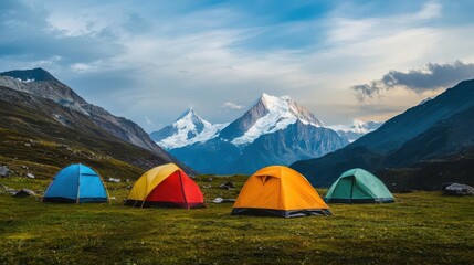 Colorful tents in a serene mountain landscape under a cloudy sky.