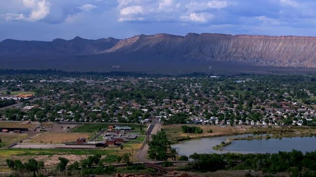 Colorado River summer Grand Junction aerial drone Grand Mesa afternoon cloudy blue sky wine vineyards Parachute Fruitvale Mt Garfield Western Close Delta downtown Main Street circle right motion