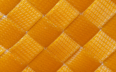 Orange woven plastic floor, slippery texture, orange plastic background, abstract background.