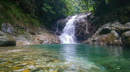 Fototapeta premium A waterfall is flowing into a small pool of water