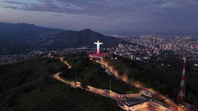 Drone panoramic view of Cristo Rey in Cali Colombia at night

