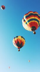 Fototapeta premium 32. A colorful hot air balloon festival against a clear blue sky