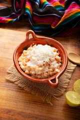 Esquites. Corn kernels cooked and served with mayo, sour cream, lemon and chili powder, very popular street food in Mexico, also known as Elote en Vaso. The recipe varies depending on the region.