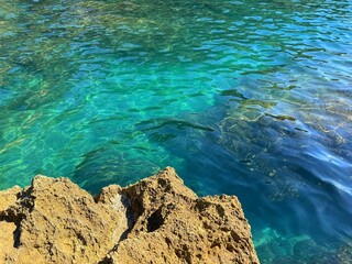 Sea turquoise blue crystal clear water and rocks.