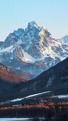 Majestic snow-capped mountain with vibrant valleys at sunrise.