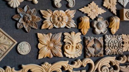 Wooden pattern elements for furniture, carving element. furniture in classic style. white color wood with gold trim. patina. carving. small depth of field. luxury furniture. use as background.
