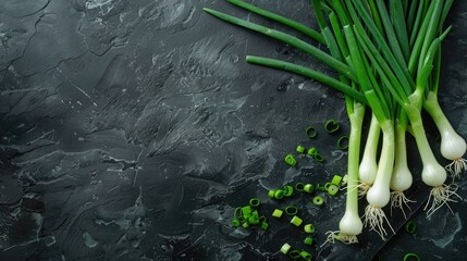 Green onions on a dark stone background