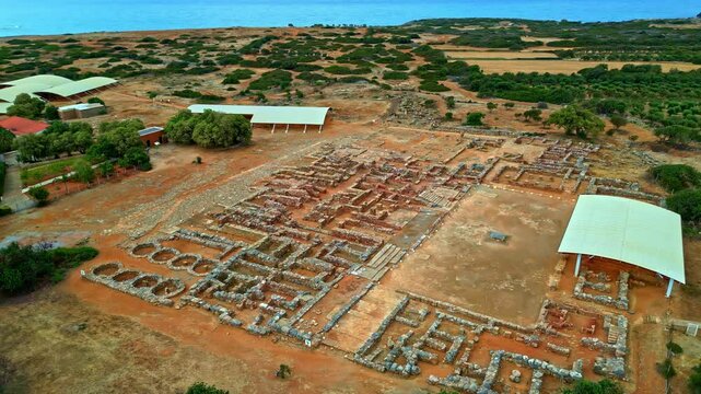 Panoramic drone shot circling the ruins of the Palace of Knossos in Crete, Greece