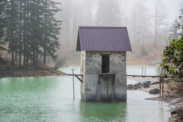 Autumn of fog and mist on the lake of Cave del Predil