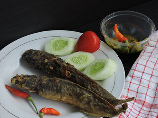 fried catfish covered in thin flour mixed with herbs and spices