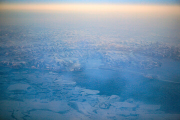 aerial view of the winter land from the flying airplane
