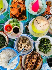 A table full of food including rice rice and vegetables