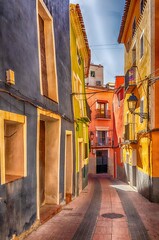 Narrow street of colourful houses in La Vela Joiosa, Costa Blanca, Spain