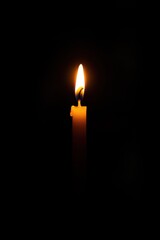 Single Candle Flame Illuminating Darkness with Hope