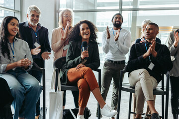Happy professionals enjoying a lively panel discussion at a corporate event