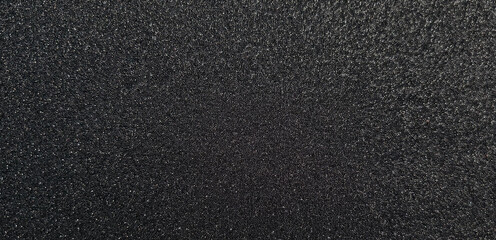 Obraz premium Metallic glitter black texture background, close up banner. Noisy black backdrop. Panoramic black metal background.
